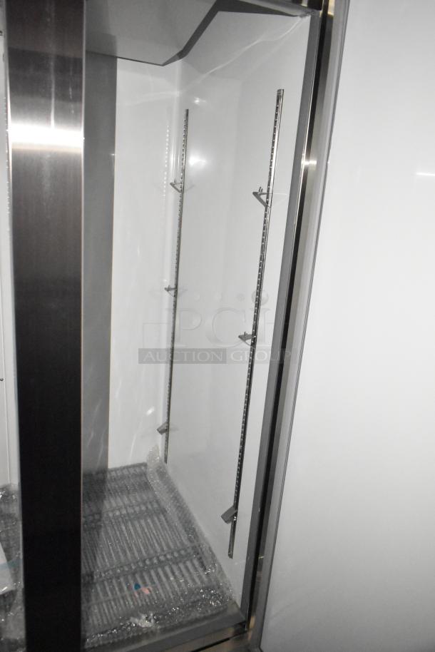 Interior of Rock Solid Cargo fast food trailer showing stainless steel shelving supports and flooring.