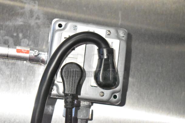 Power outlets with black and gray cords in a Rock Solid Cargo fast-food trailer.