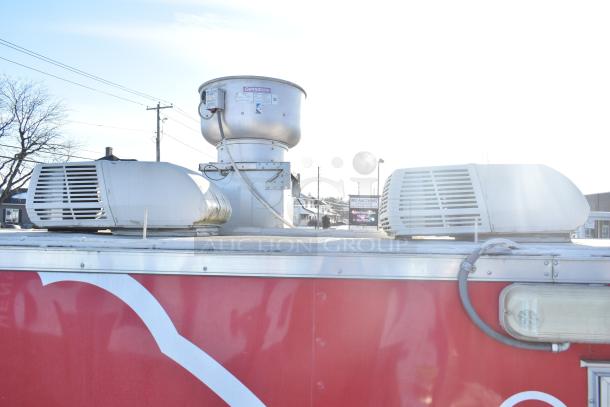 Rock Solid Cargo fast food trailer roof with CaptiveAire grease hood and air units, part of a fully equipped mobile kitchen.