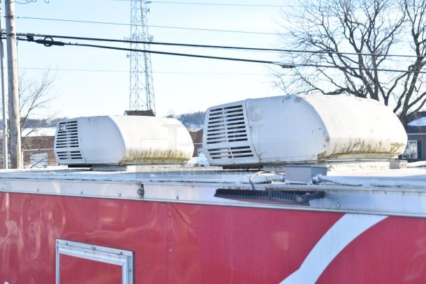 Roof view of a Rock Solid Cargo fast food trailer, showing two white rooftop air conditioning units on a red exterior.