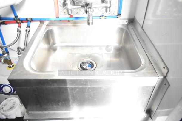 Stainless steel sink with faucet and plumbing fixtures in Southern Dimensions 24' unbranded food trailer.