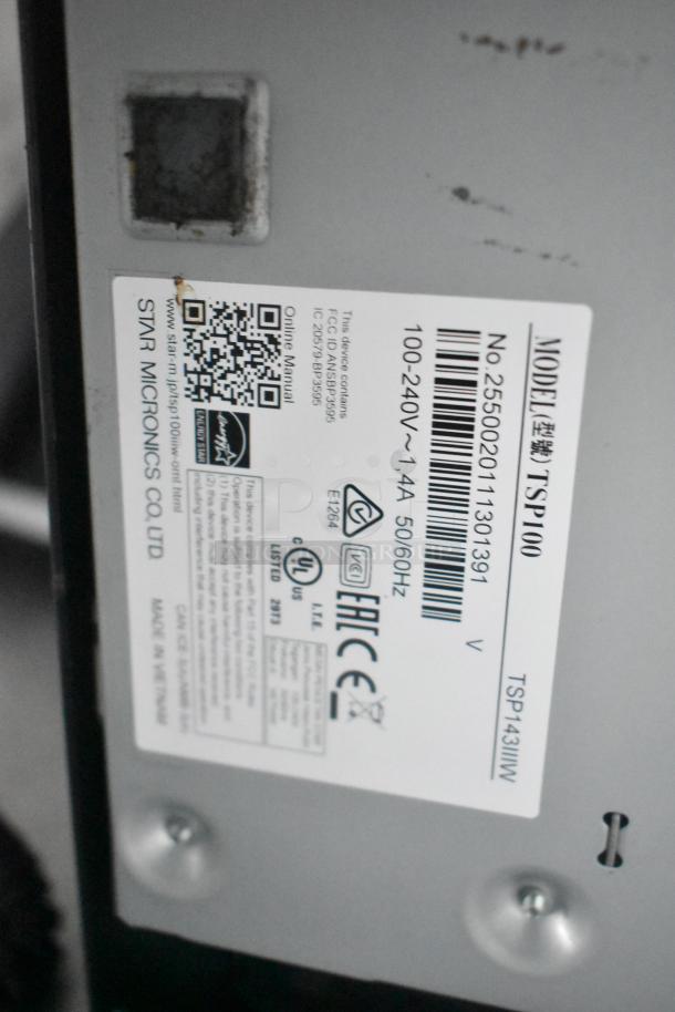 Label showing specifications for Star Micronics TSP100 printer, model TSP143IIIW. Includes power details and QR codes.