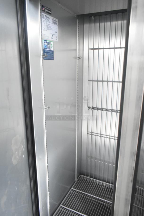Interior view of Southern Dimensions 24' unbranded retail trailer with True reach-in cooler, wire shelving, and commercial fixtures.