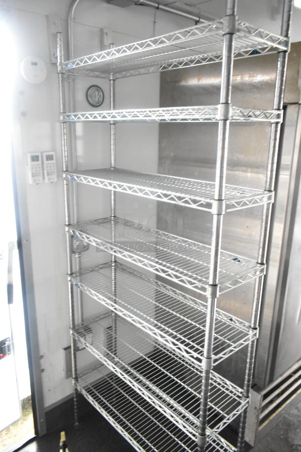 Southern Dimensions 24' retail trailer interior with wire shelving units, temp controls, and commercial cooler. New, fully equipped.