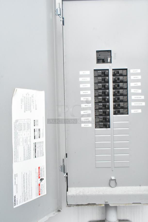 Electrical panel inside Southern Dimensions 24' cold food trailer showing labeled circuit breakers for appliances and equipment.