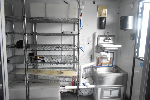 Southern Dimensions 24' trailer interior showing wire shelving, commercial sink, and utility fixtures. Ready for use.