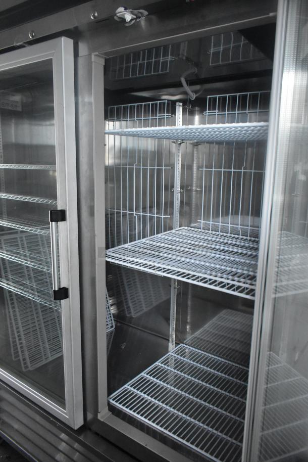 Two-door commercial cooler in a stainless steel Southern Dimensions trailer, featuring wire shelving, ready for use.