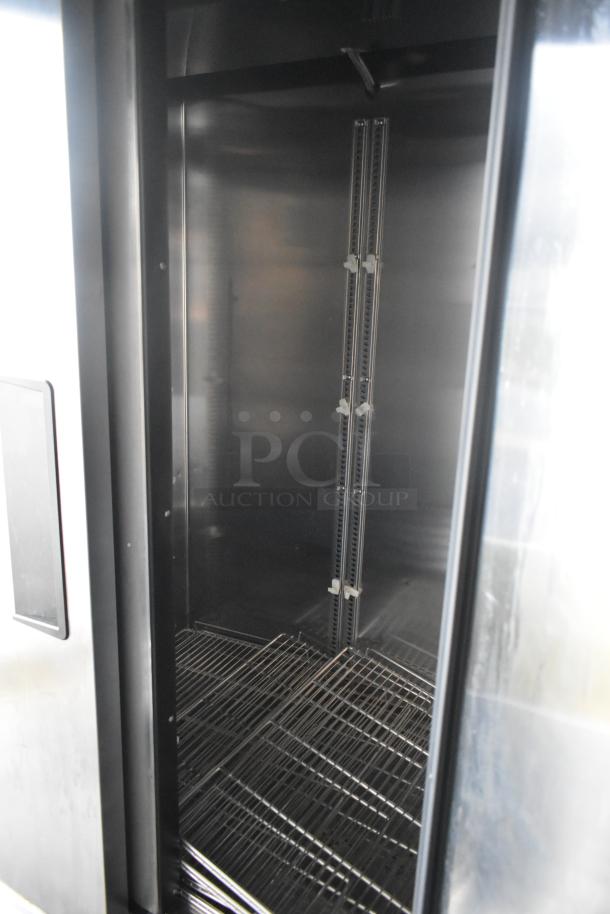 Interior view of commercial cooler inside Southern Dimensions 24' outfitted trailer, showing wire shelving and stainless steel finish.