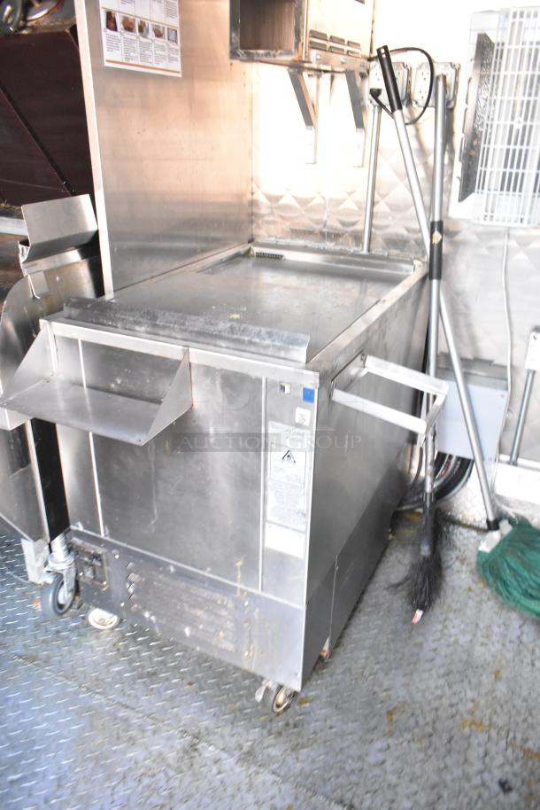 Fully equipped Wendy's fast food trailer interior with commercial-grade appliances, including fryer and grill. Kitchen fixtures visible.