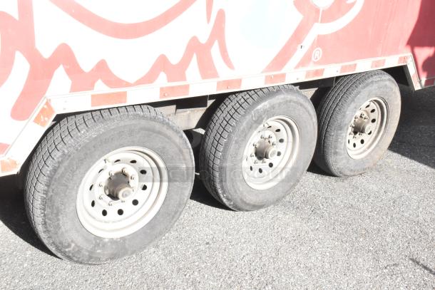 Close-up of the wheels on a 28' Wendy's fast food trailer. Features include sturdy rims and tires, ready for mobile operations.