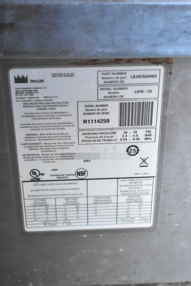 Label on Taylor appliance showing part number L81023GWWD, model L810-23, serial N1114259, commercial cooking appliance.