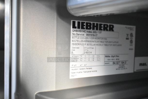 Label on Liebherr bottle cooler indicating model GRB05S1HC, Class 5, with specifics on cooling capacity and insulation.