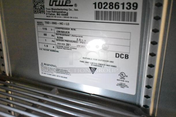 Label on True Manufacturing refrigeration unit, model TSD-09G-HC-LD, lists specifications and safety warnings for outdoor use.