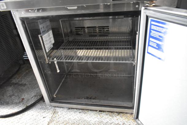 Open commercial-grade cooler inside a 28' Wendy's fast food trailer. Steel shelves, clear interior, visible label with specifications.