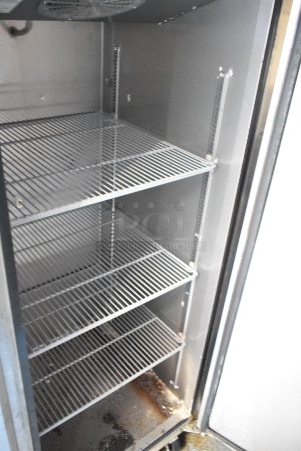 Open metal shelving inside a commercial-grade cooler, part of a 28' outfitted Wendy's mobile kitchen trailer.