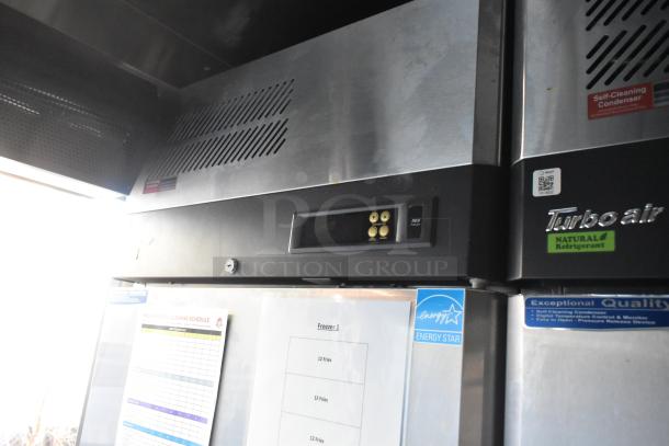 Turbo Air freezer unit in a 28' Wendy's fast food trailer, featuring control panel, Energy Star label, and cleaning schedule.
