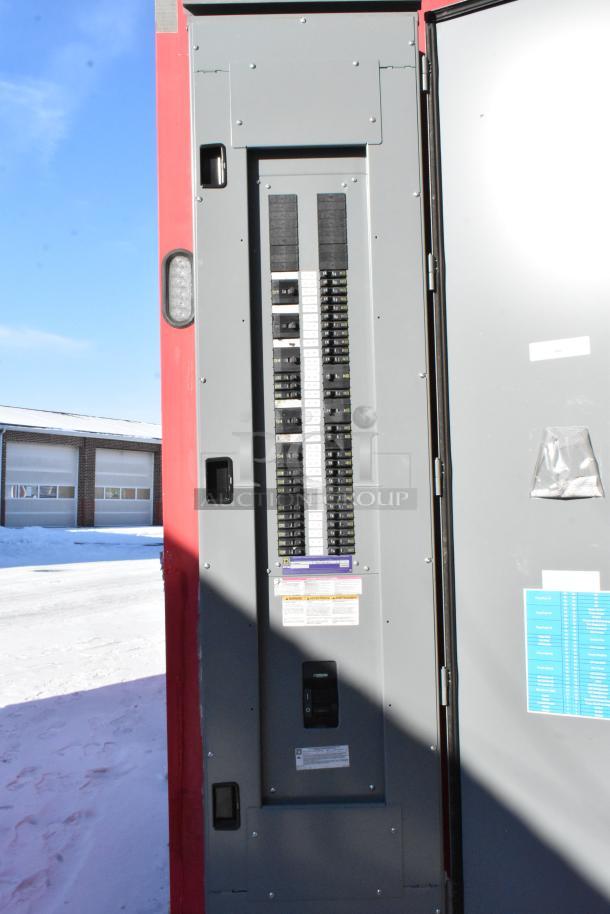 Electrical panel inside Wendy's 28' mobile kitchen trailer, showcasing circuit breakers and safety labels.
