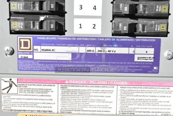 Electrical panelboard with labels showing circuit breaker specifics. Features a catalog number NQ484L4C and safety warnings.