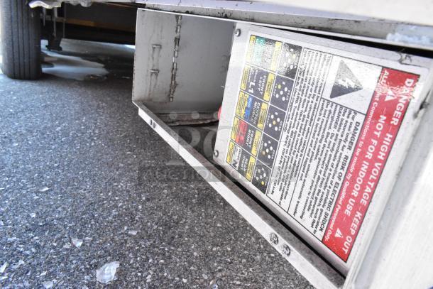 High voltage warning label on a Wendy's fast food trailer. Indicates outdoor use only; essential safety feature.