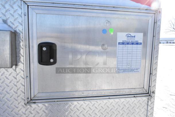 Metallic panel of a 28' Wendy's fast food trailer with "United" service record label displayed.
