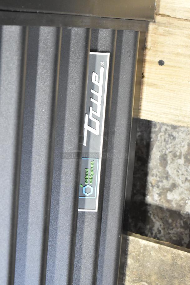 True TVM-48SL-HC commercial cooler label on door, highlighting natural refrigerant feature. Brand new with minor scratches.