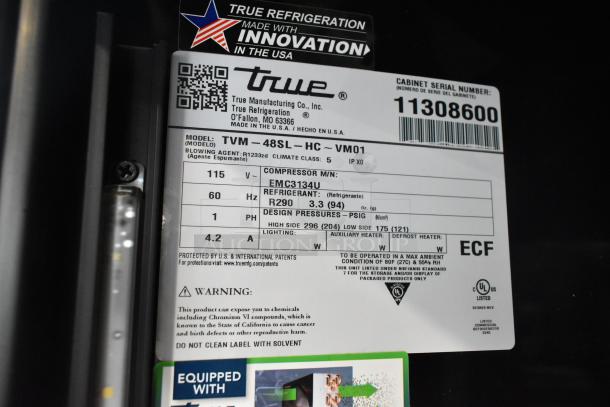 BRAND NEW scratch and dent 2025 True TVM-48SL-HC commercial cooler. 2-door reach-in, 115 volts, 1 phase. Model label visible.