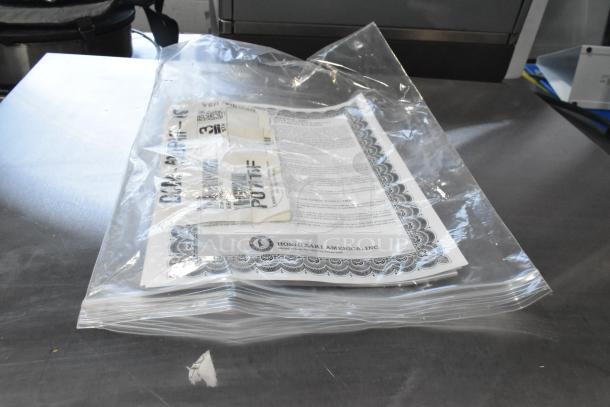 Clear plastic bag containing Hoshizaki DCM-500BAH-OS documentation and labels for water and ice dispenser.