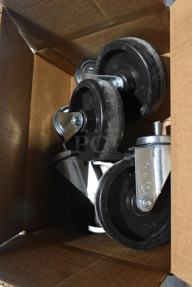Box of caster wheels, new condition, suitable for Hoshizaki SR72B-30M prep table. Durable metal frame, black rubber wheels.