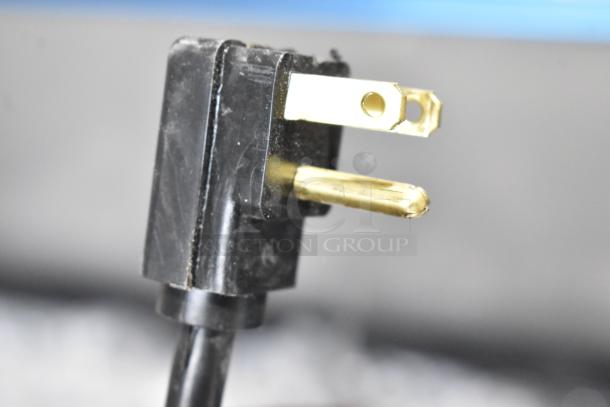 Close-up of a three-prong electrical plug for the Hoshizaki SR72B-30M prep table. Black casing, gold prongs intact.