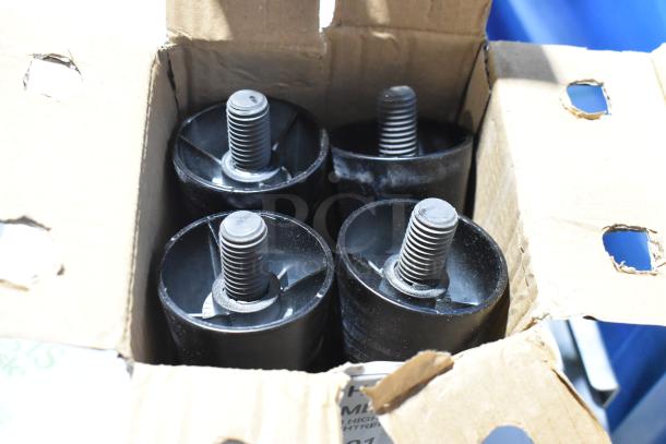 Box of four black caster wheels in new condition inside cardboard packaging.