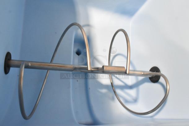 Alt text: Inside view of 2025 Hoshizaki DB-200H Cube Ice Dispenser, showing metal auger within blue compartment.