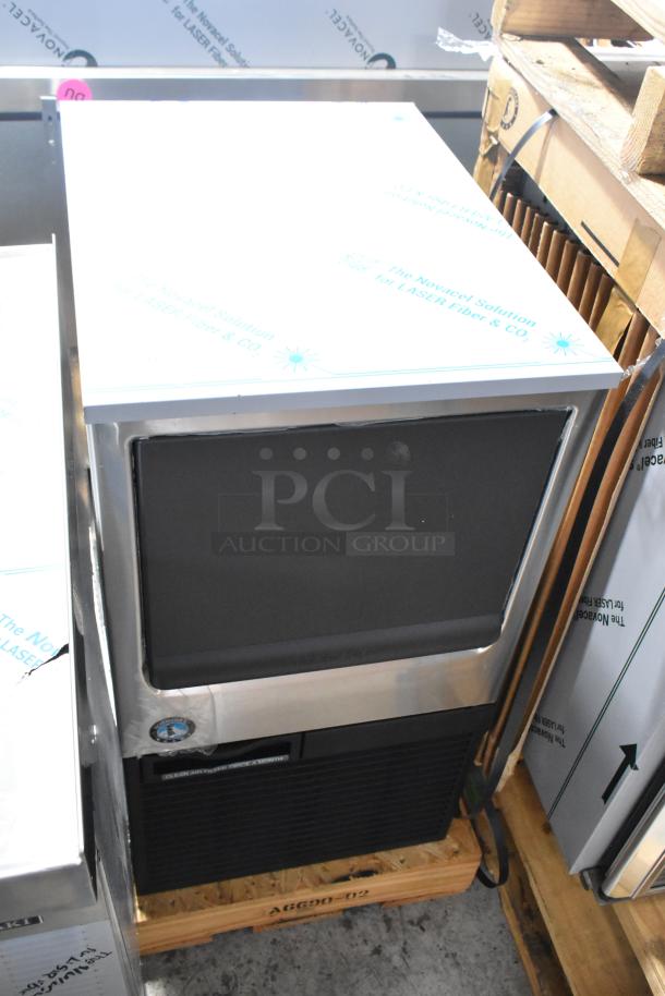 Brand new 2026 Hoshizaki commercial ice machine, self-contained, stainless steel finish, on wooden pallet, pristine condition.
