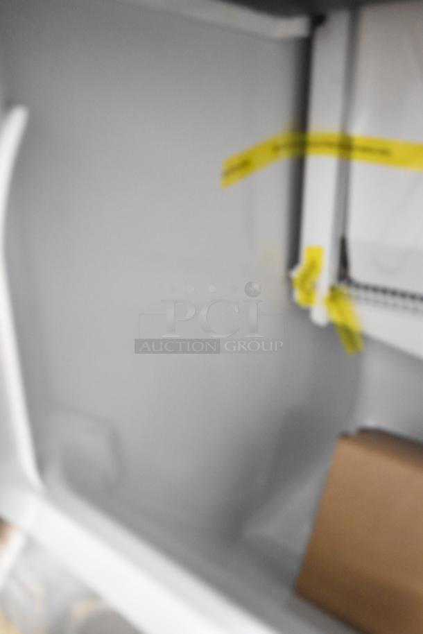 Brand new 2026 Hoshizaki commercial self-contained ice machine interior with visible packing tape.