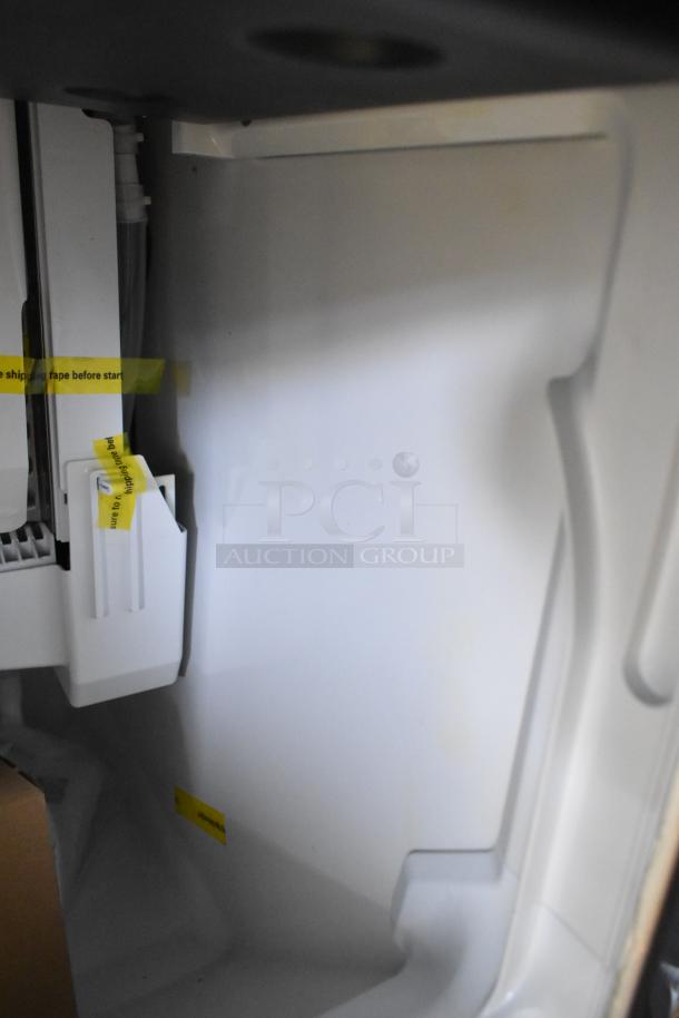 BRAND NEW 2026 Hoshizaki commercial ice machine interior, pristine condition, with yellow shipping tape indicating new status.
