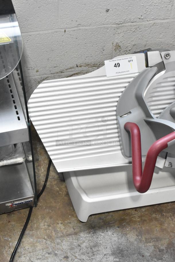 Berkel X13A commercial meat slicer, 120V, single phase. Features ergonomic handle, robust design. Auction tag visible.
