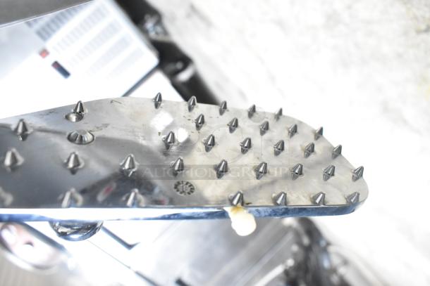 Globe Chefmate GC512 commercial meat slicer with blade sharpener, 115 volts, spiked grip plate shown.