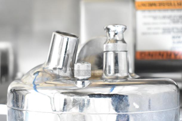 Globe Chefmate GC512 meat slicer detail, showcasing metal components. Includes integrated blade sharpener. 115V, 1 Phase.