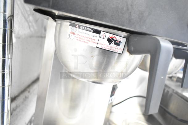 Galaxy 177GCM2 BRUG20C01 pourover coffee maker with 2 warmers and toggle controls, featuring a warning label.