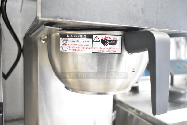 Galaxy 177GCM2B Pourover Coffee Maker with stainless steel pot and safety label. Features 2 warmers, toggle controls.