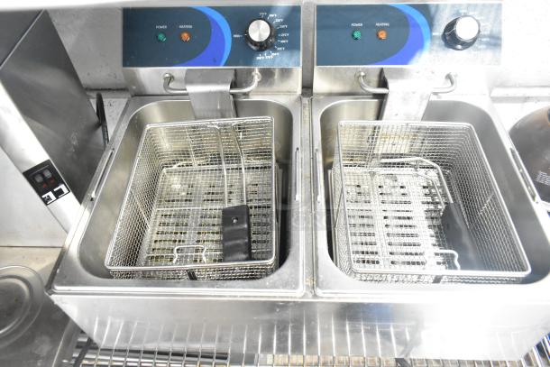 Brand new Hoocoo FRY-20L stainless steel commercial deep fryer with 2 bays, metal baskets, and lids. 120V, 1 phase.