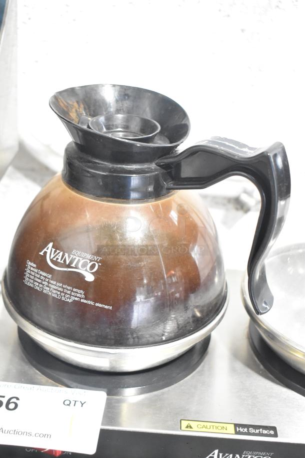 Avantco coffee pot warmer with two pots, model 177W52. Features: stainless steel build, visible "Caution" hot surface label. Used condition.