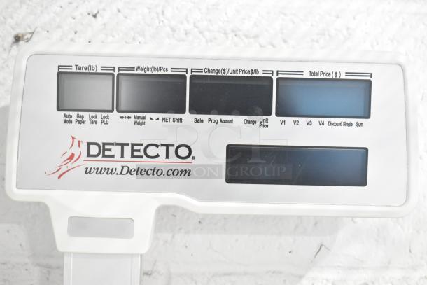 Detecto DL1030P digital price computing scale with label printer and pole display, features visible control panel.