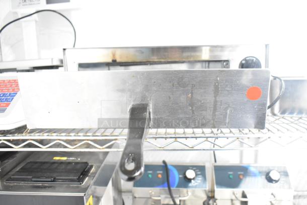 Carnival King 382CPO12TS stainless steel countertop pizza oven, adjustable thermostat, visible wear, 120 volts.