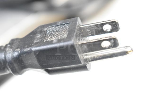 Close-up of a three-prong electrical plug for the Avantco 178APPT91HC Commercial Pizza Prep Table. Black plastic, 115 volts.