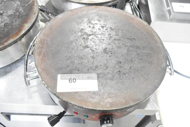 Waring WSC160 16" electric crepe maker, 120 volts, 1 phase. Features well-used surface and temperature controls. Auction tag visible.