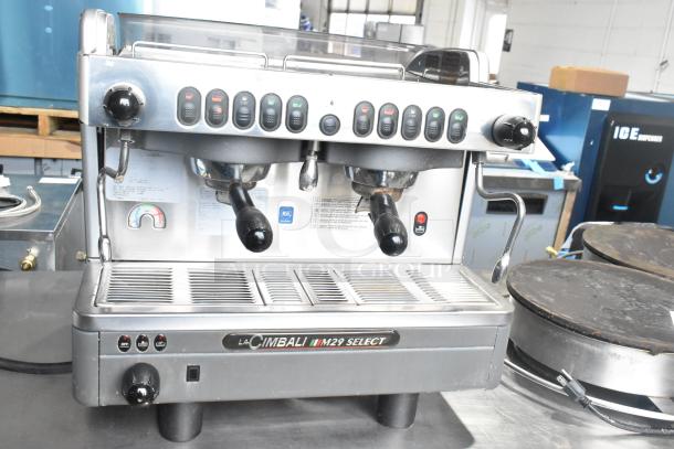 La Cimbali M29 Select DT/2-NF commercial espresso machine with 2 portafilters, 2 steam wands, visible controls, and labels.