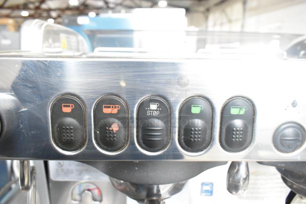 La Cimbali M29 Select DT/2-NF espresso machine control panel with labeled cup and stop buttons, visible wear.