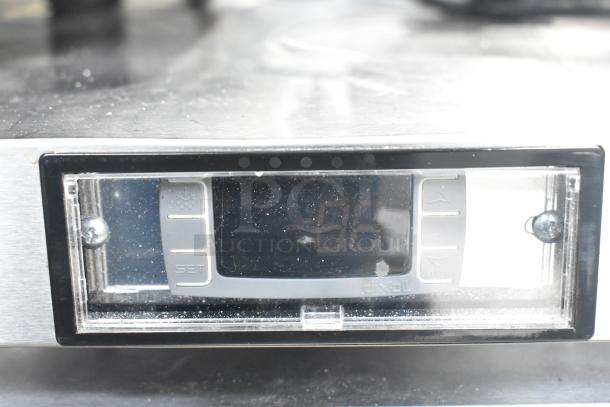 Digital control panel of 2019 Migali C-U72R-HC undercounter cooler showing temperature, model markings visible.