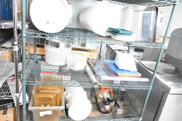 Three-tier metal shelf with various items including coffee pots, poly drop-in bin lids, and cylindrical bins. Items in used condition.