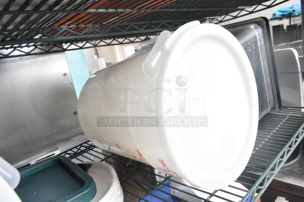 Three-tier shelving with coffee pots, poly drop-in bin lids, and poly cylindrical bins in good condition.